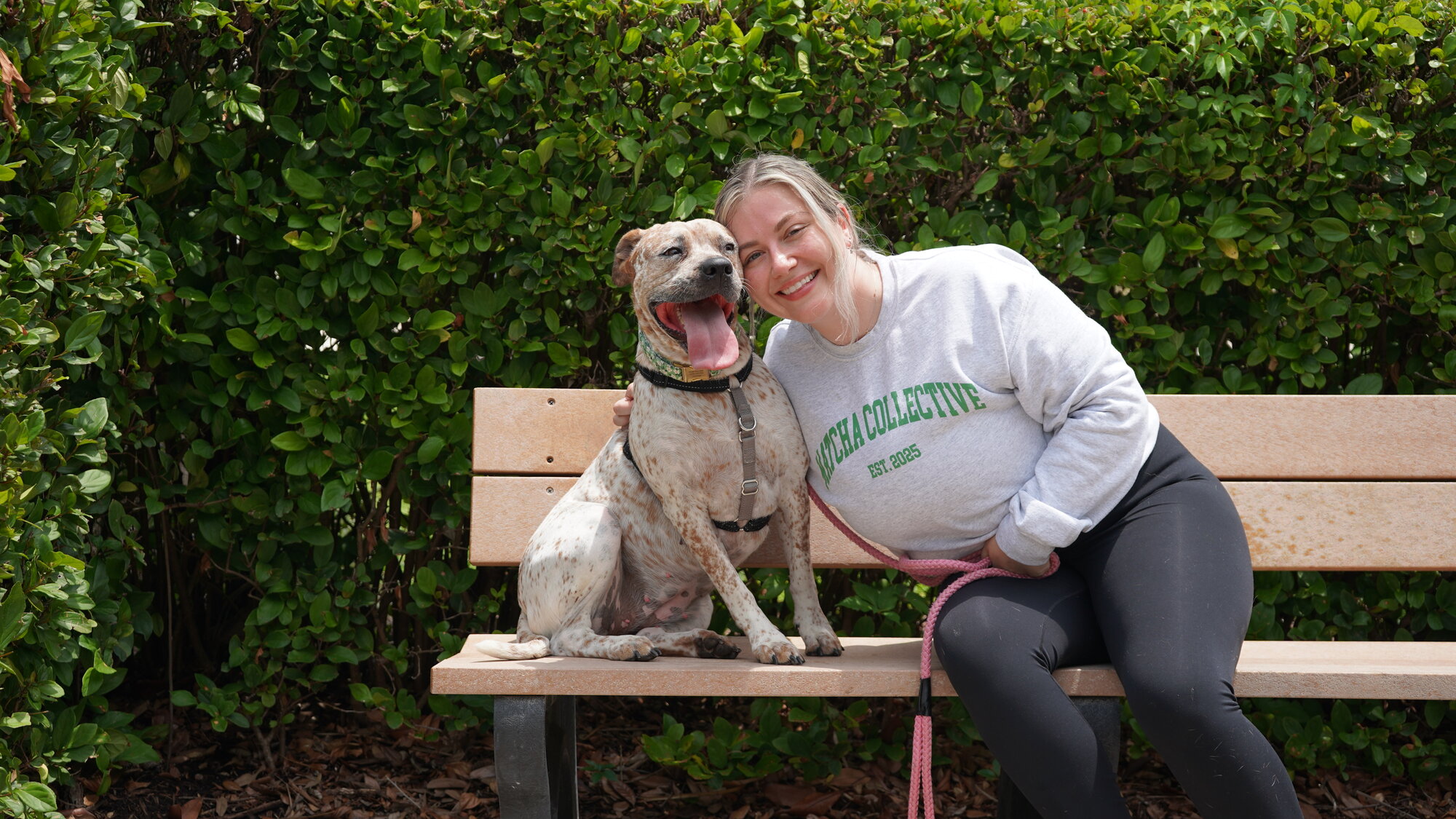 Vanessa Haliday, founder of Matcha Collective, with her rescue pup Matcha on a park bench